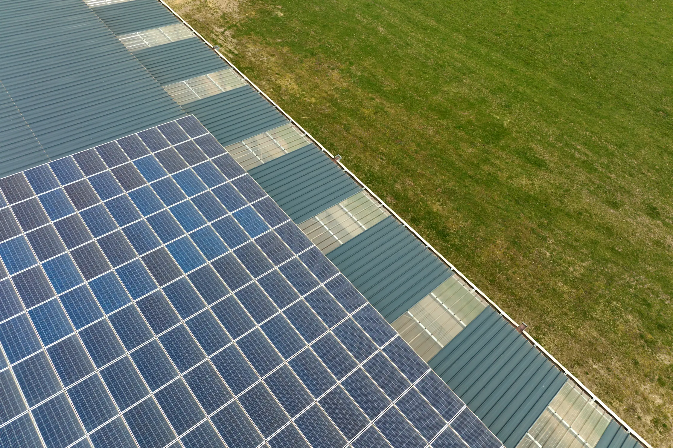 aerial-view-solar-power-plant-with-blue-photovoltaic-panels-mounted-industrial-building-roof-producing-green-ecological-electricity-production-sustainable-energy-concept